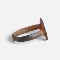 Medieval bronze ring 'Radvina' shows its thin lobed bezel edge and hoop from the side.