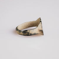 Side profile of Roman bronze ring Numerius revealing patina and hoop shape