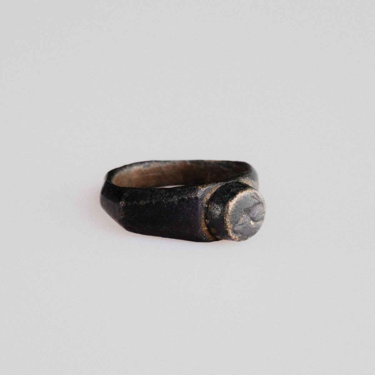 Side profile of Roman bronze ring Numerius showing wide shoulders and D-section hoop