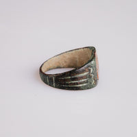 Side profile of Roman bronze ring Palmata showing D-section hoop and patina