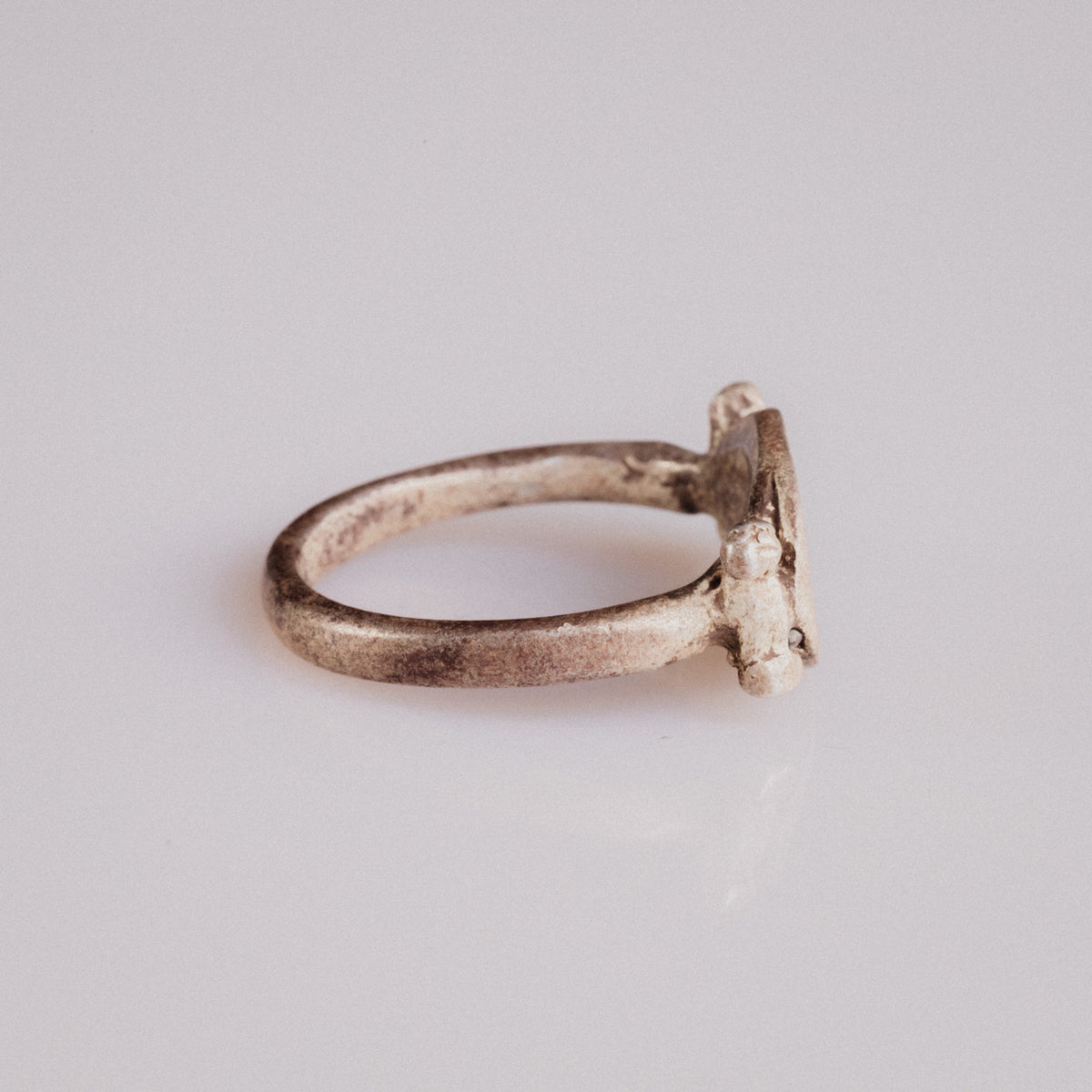 Side profile of Roman silver ring Numeria showing cylindrical shoulder bars and tapering D-section hoop