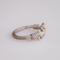 Roman silver wire ring 'Nodus' shows its plain hoop and wound shoulders in side profile.