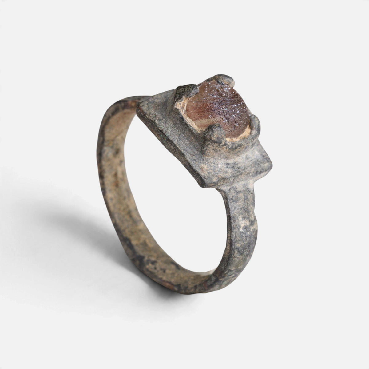 Medieval bronze ring 'Aldonza' shows its raised reddish setting and complete hoop from another angle.