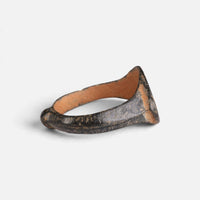 Medieval bronze ring 'Rhombulus' shows its thin bezel edge and broad hoop from the side.