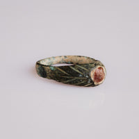 Side view of medieval bronze ring Vetrona showing raised oval bezel and D-section hoop