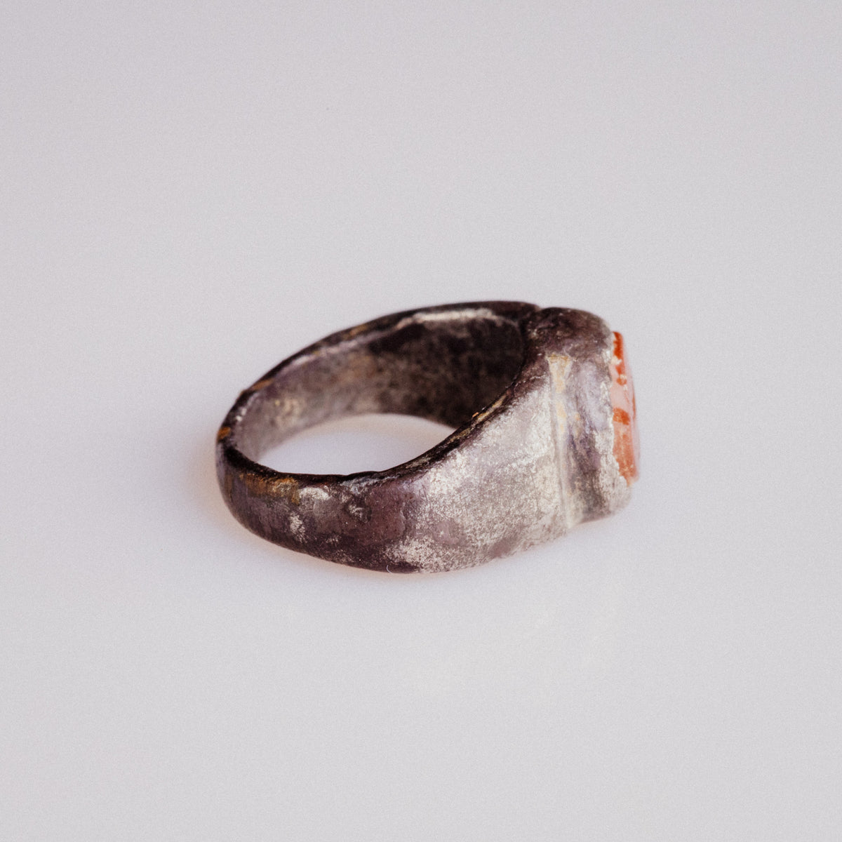 Side view of Roman silver ring Pisculus revealing D-section hoop and patina