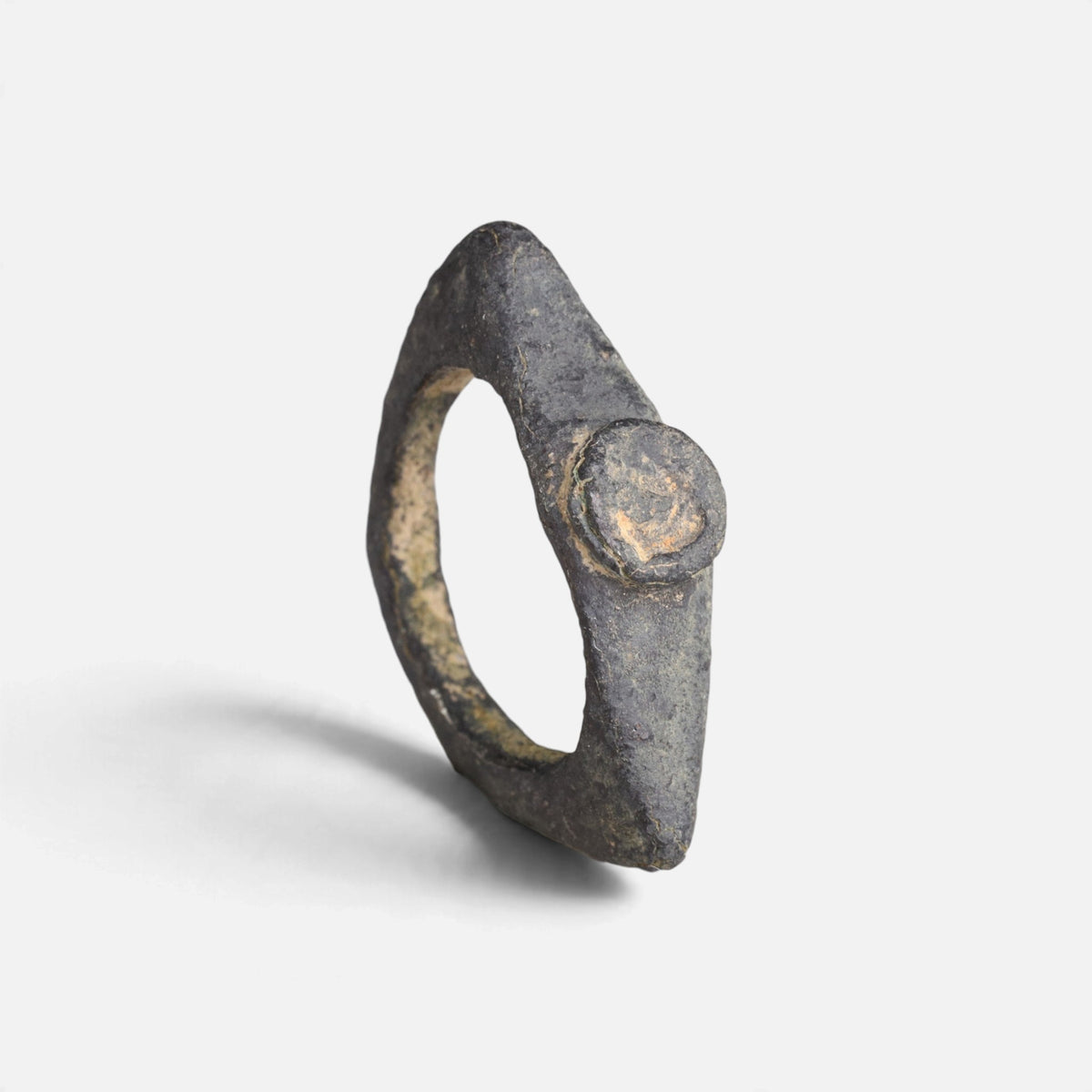Roman bronze ring 'Equidus' shows its small round bezel and pointed shoulders at an angle.