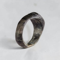 Side view of Vespasia medieval bronze ring highlighting patina and worn hoop exterior