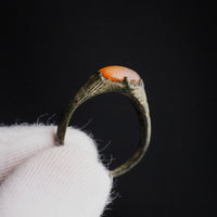 Studio close-up of medieval bronze ring Vukmir cabochon held in prong setting