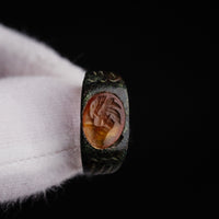 Studio detail of Roman bronze ring Palmata carnelian intaglio in gloved hand