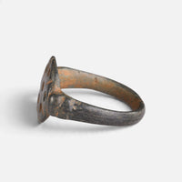 Byzantine bronze ring 'Heliona' shows its circular bezel edge and hoop from the opposite side.