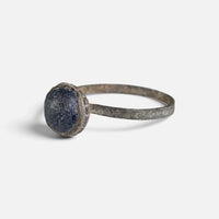 Byzantine bronze ring 'Kaloira' shows its blue setting and narrow hoop from the opposite front angle.