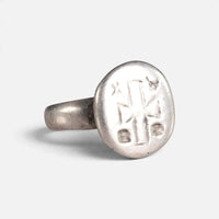 Byzantine silver ring 'Chrysanthos' shows its circular bezel engraving and shoulder at an angle.