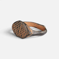 Medieval bronze ring 'Rhombulus' shows its cross-hatched navette bezel from the opposite front angle.