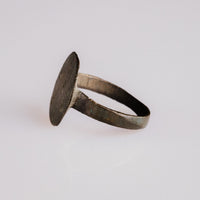 Three-quarter view of medieval bronze ring Rurik highlighting patina and hoop profile
