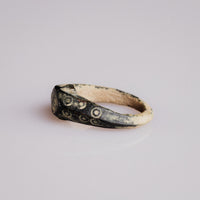 Three-quarter view of Roman bone ring Numerius with ocelli cluster on bezel