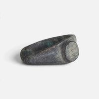 Roman bronze ring 'Hesperia' shows its worn circular bezel and broad shoulder at an angle.