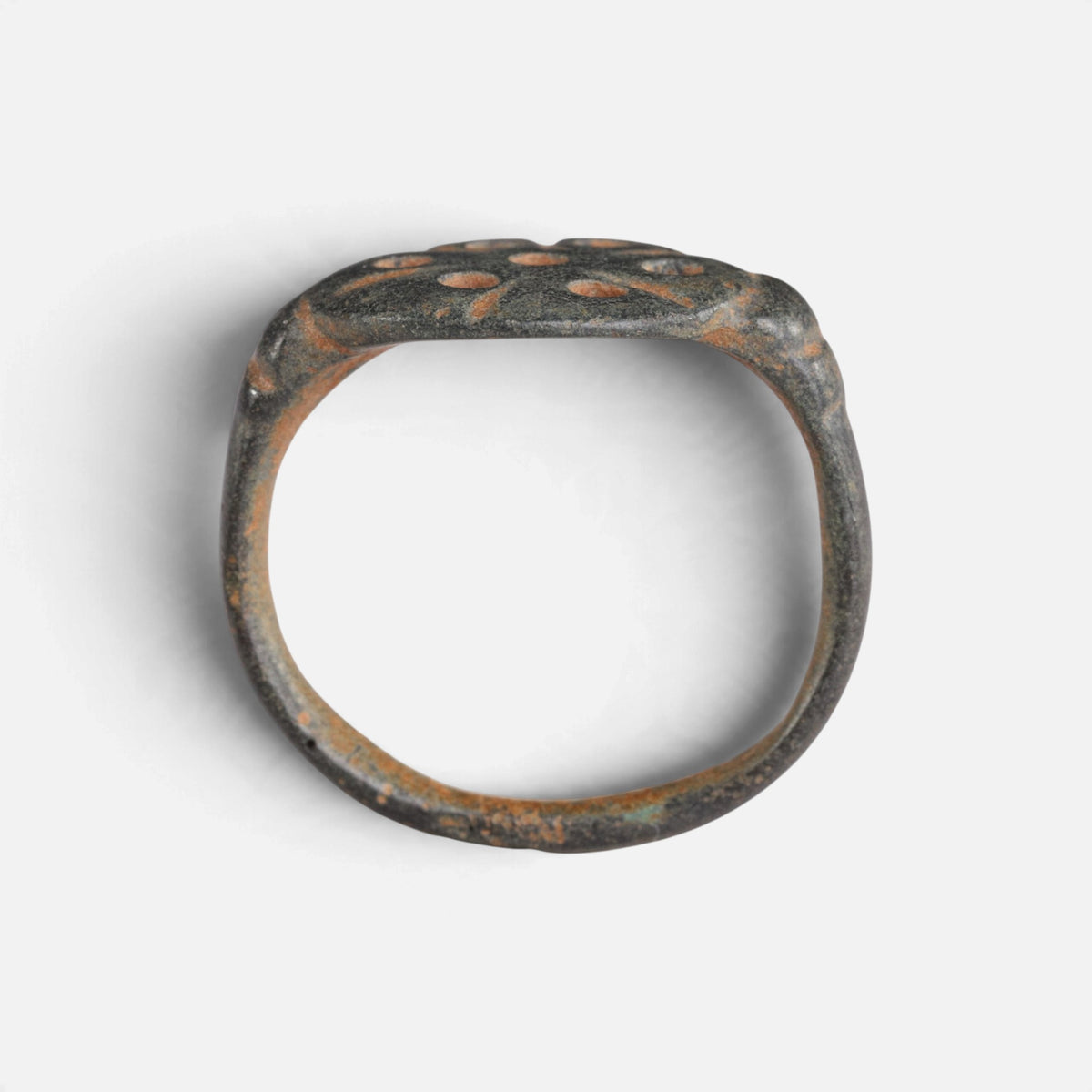 Byzantine bronze ring 'Heliona' shows its broad hoop and pierced bezel edge in profile.