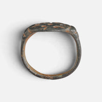 Byzantine bronze ring 'Heliona' shows its broad hoop and pierced bezel edge in profile.
