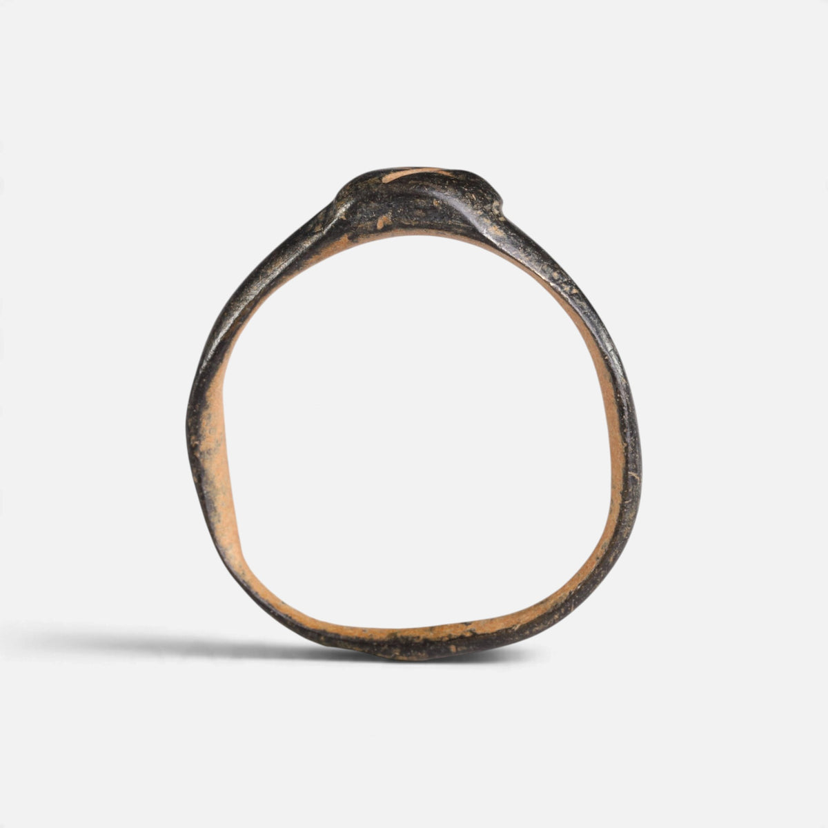 Byzantine bronze ring 'Isidoros' shows its complete hoop and the narrow bezel edge in profile.