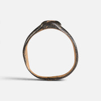 Byzantine bronze ring 'Isidoros' shows its complete hoop and the narrow bezel edge in profile.