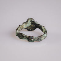 Top-down view of medieval bronze ring Quintus revealing quatrefoil bezel silhouette