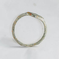 Top-down view of medieval bronze ring Stellira revealing the thin cast hoop and diamond bezel silhouette