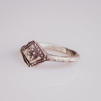 Top-down view of medieval silver ring Ruslan with clear tooth-pattern bezel border