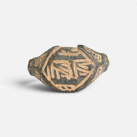 Medieval Islamic bronze ring 'Nasirun' shows angular engraved strokes within the border of its bezel from the front.