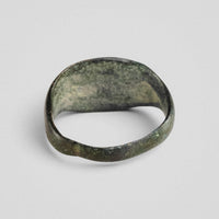 Top-down view of Roman bronze ring Equirius revealing hoop taper toward the rear