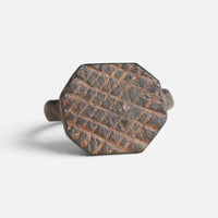 Medieval bronze ring 'Anselm' shows the lattice engraving on its octagonal bezel from the front.