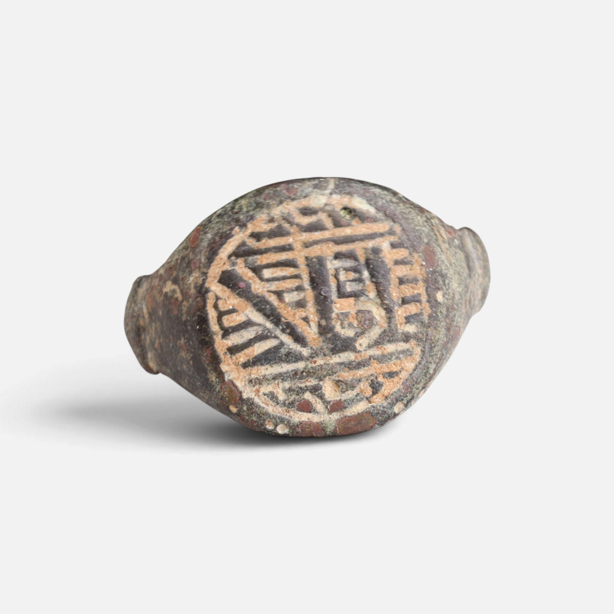 Medieval Islamic bronze ring 'Tahir' shows angular engraved strokes within the round bezel border from the front.