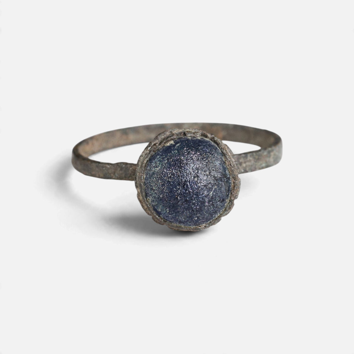 Byzantine bronze ring 'Kaloira' shows its blue setting and narrow band from the front.
