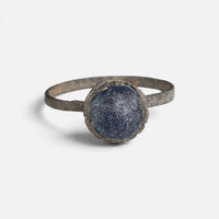 Byzantine bronze ring 'Kaloira' shows its blue setting and narrow band from the front.