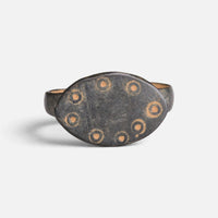 Byzantine bronze ring 'Okellina' shows ring-and-dot marks around the plain centre of its oval bezel.