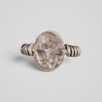 Top view of Roman silver ring Veneria showing oval engraved plate with draped bust