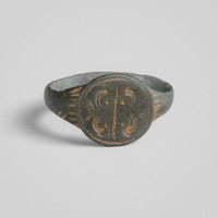 Top view of medieval bronze ring Lioris with symmetrical scrollwork device