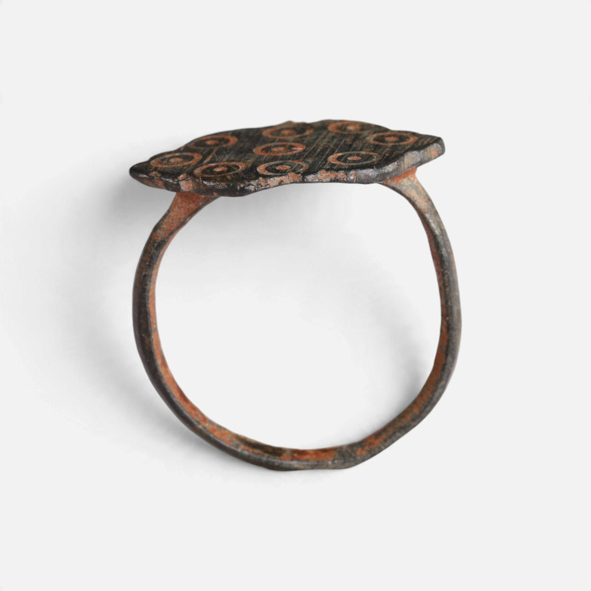 Medieval bronze ring 'Radvina' shows its lobed bezel edge above the complete hoop in profile.
