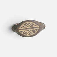 Medieval bronze ring 'Radwin' shows the geometric engraving on its navette bezel from the front.