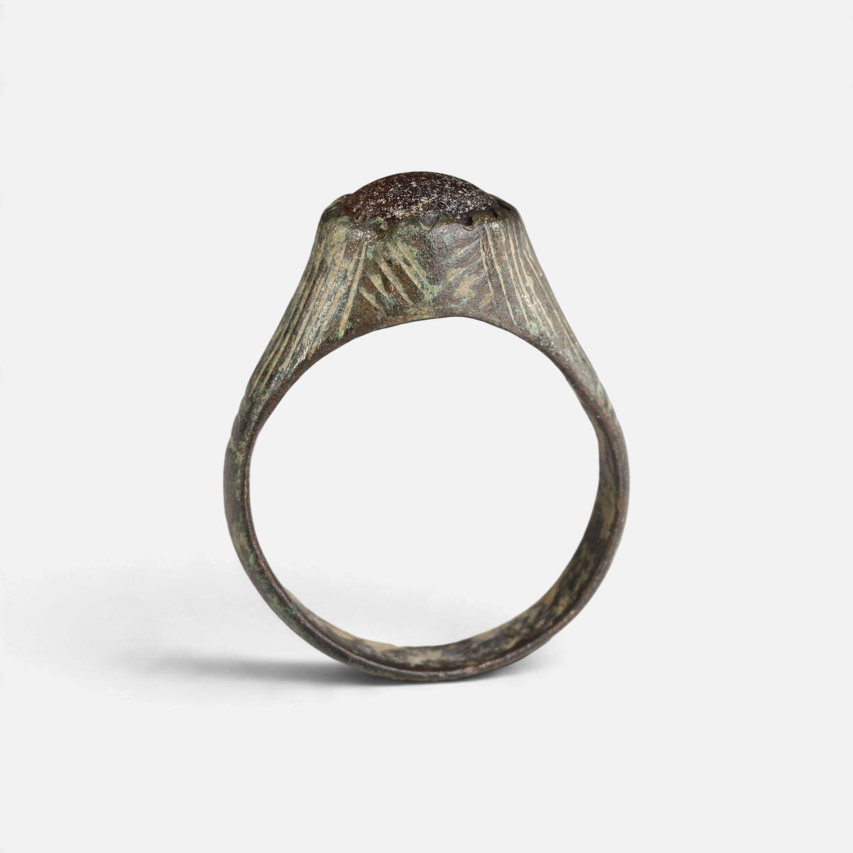 Medieval bronze ring 'Radwina' shows the raised setting edge above its complete hoop in profile.