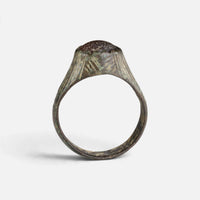 Medieval bronze ring 'Radwina' shows the raised setting edge above its complete hoop in profile.