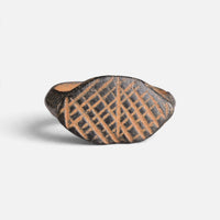 Medieval bronze ring 'Rhombulus' shows the cross-hatched engraving on its pointed oval bezel from the front.