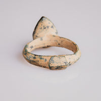 Top view of medieval bronze ring Zvezdan revealing multi-toned malachite and ochre patina