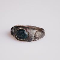 Top view of Roman bronze ring Volusenus highlighting oval bezel and worn palm branch motif