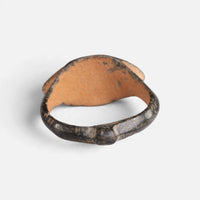 Medieval bronze ring 'Rhombulus' shows the plain back of its pointed oval bezel and the inner hoop.