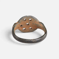 Byzantine bronze ring 'Heliona' shows the openings through the back of its bezel and the inner hoop.