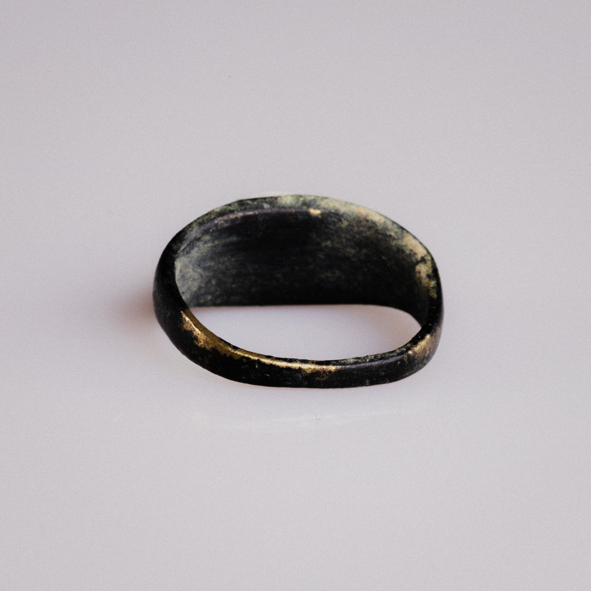 Underside view of Roman bronze ring Numerius showing worn inner band and patina